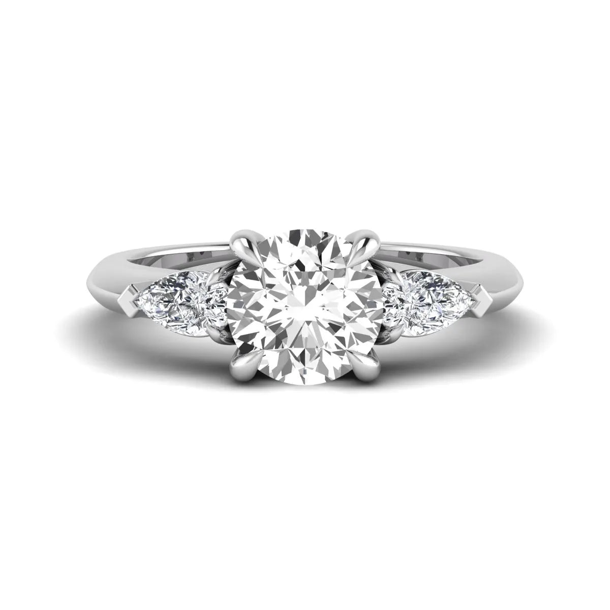 IGI certified round cut lab grown diamond three stone engagement ring with pear side diamonds in white gold.