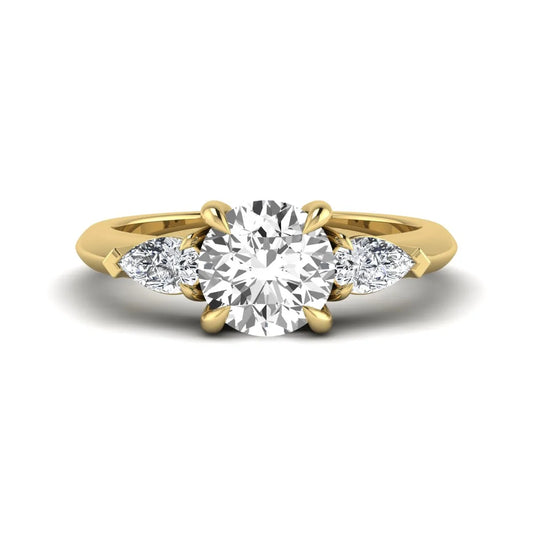 IGI certified round cut lab grown diamond three stone engagement ring with pear side diamonds in yellow gold.