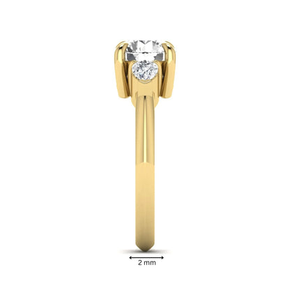 IGI certified round cut lab grown diamond three stone engagement ring with pear side diamonds in yellow gold.