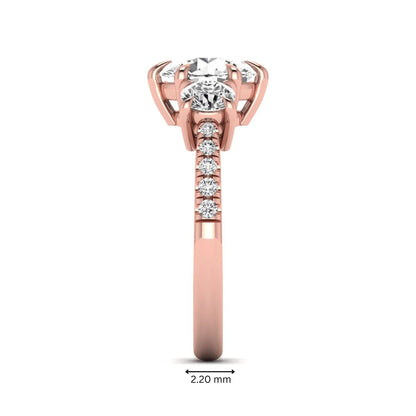 Round cut lab grown diamond three stone engagement ring with two round side diamonds and diamond accented shoulders in rose gold