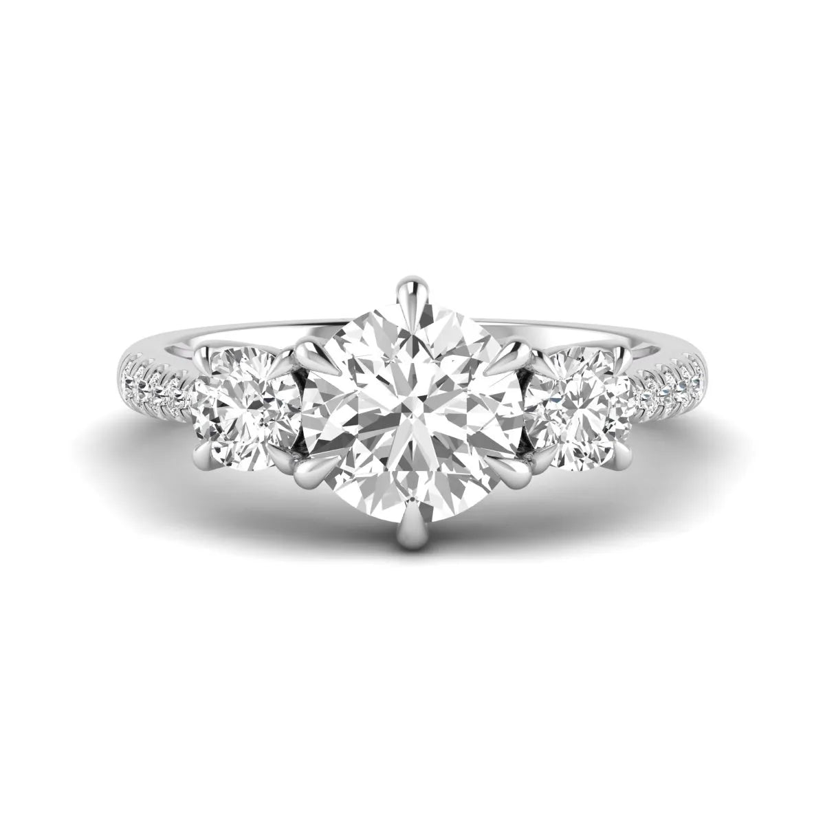 Round cut lab grown diamond three stone engagement ring with two round side diamonds and diamond accented shoulders in white gold