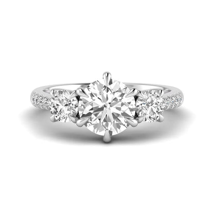 Round cut lab grown diamond three stone engagement ring with two round side diamonds and diamond accented shoulders in white gold