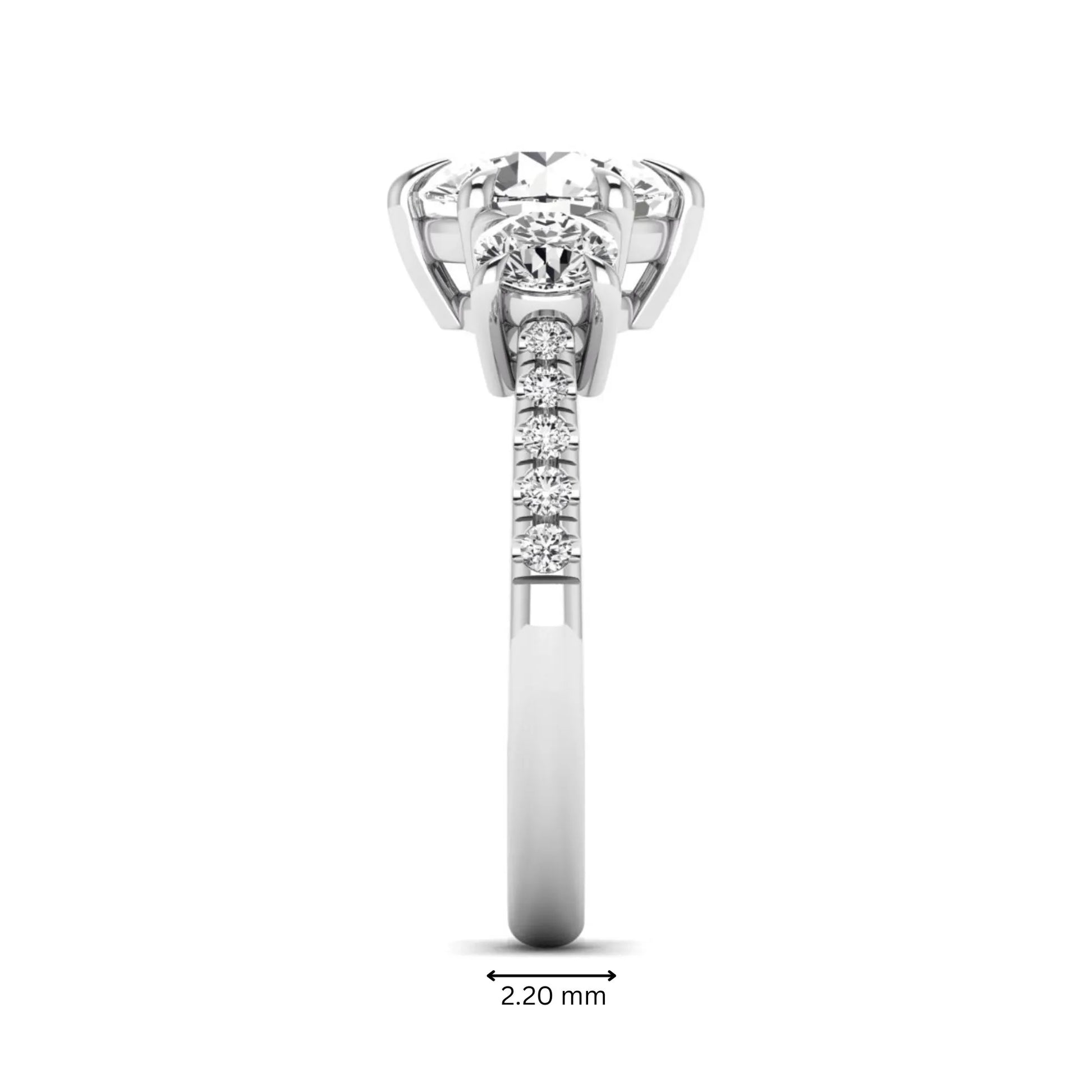 Round cut lab grown diamond three stone engagement ring with two round side diamonds and diamond accented shoulders in white gold
