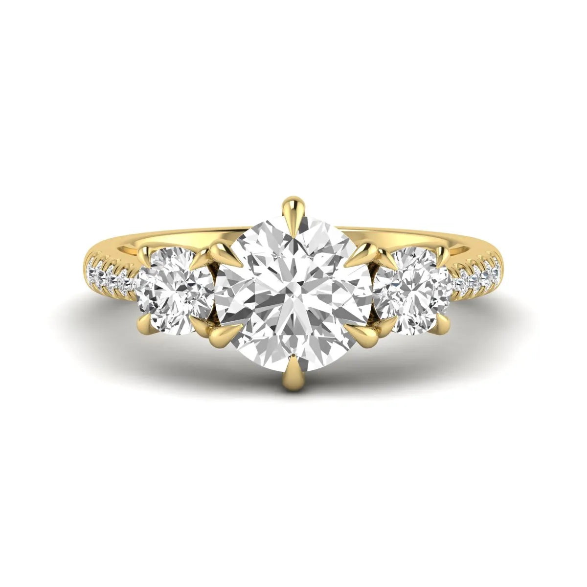 Round cut lab grown diamond three stone engagement ring with two round side diamonds and diamond accented shoulders in yellow gold