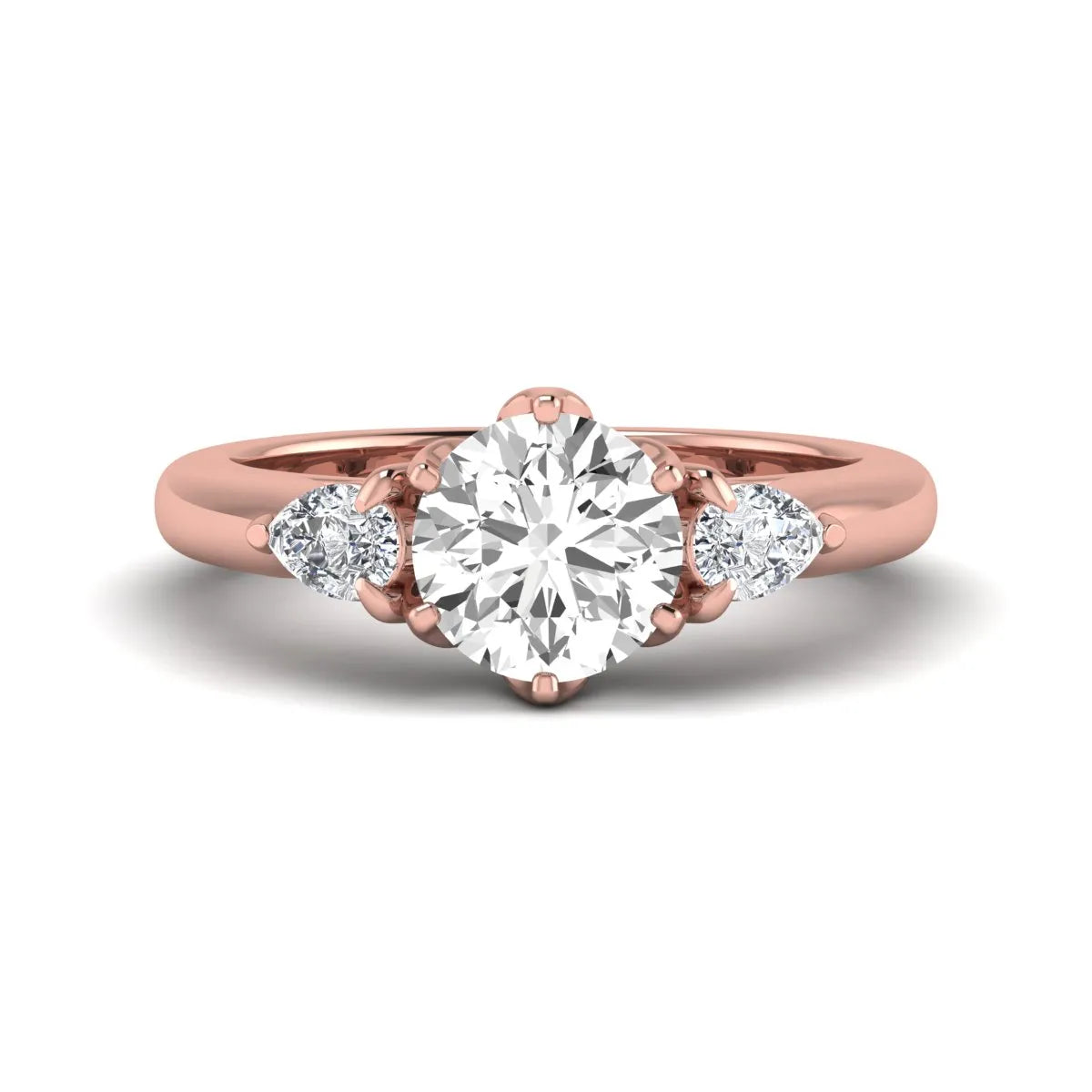 Round cut lab grown diamond three stone engagement ring with pear side diamonds in rose gold.