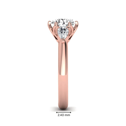 Round cut lab grown diamond three stone engagement ring with pear side diamonds in rose gold.