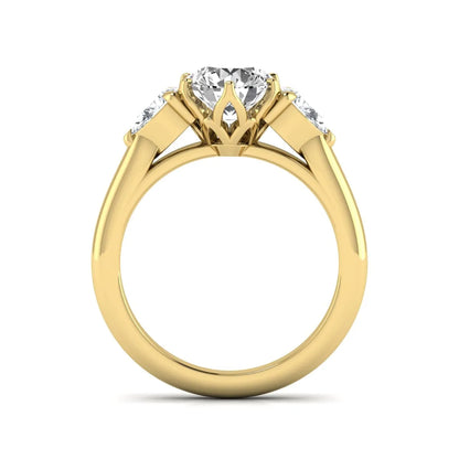 Round cut lab grown diamond three stone engagement ring with pear side diamonds in yellow gold.
