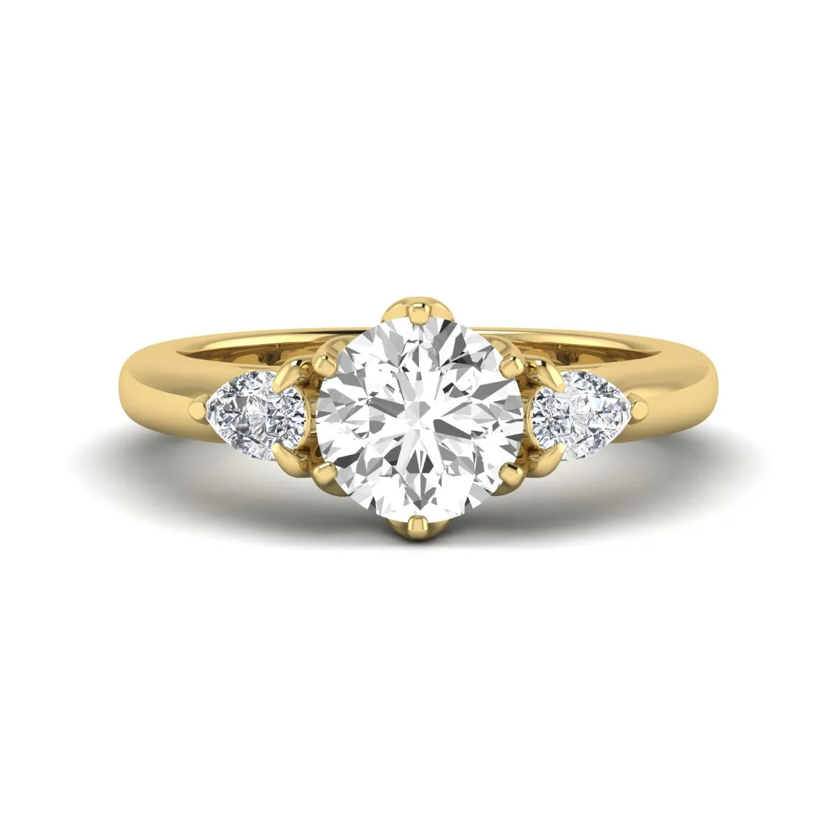 Round cut lab grown diamond three stone engagement ring with pear side diamonds in yellow gold.