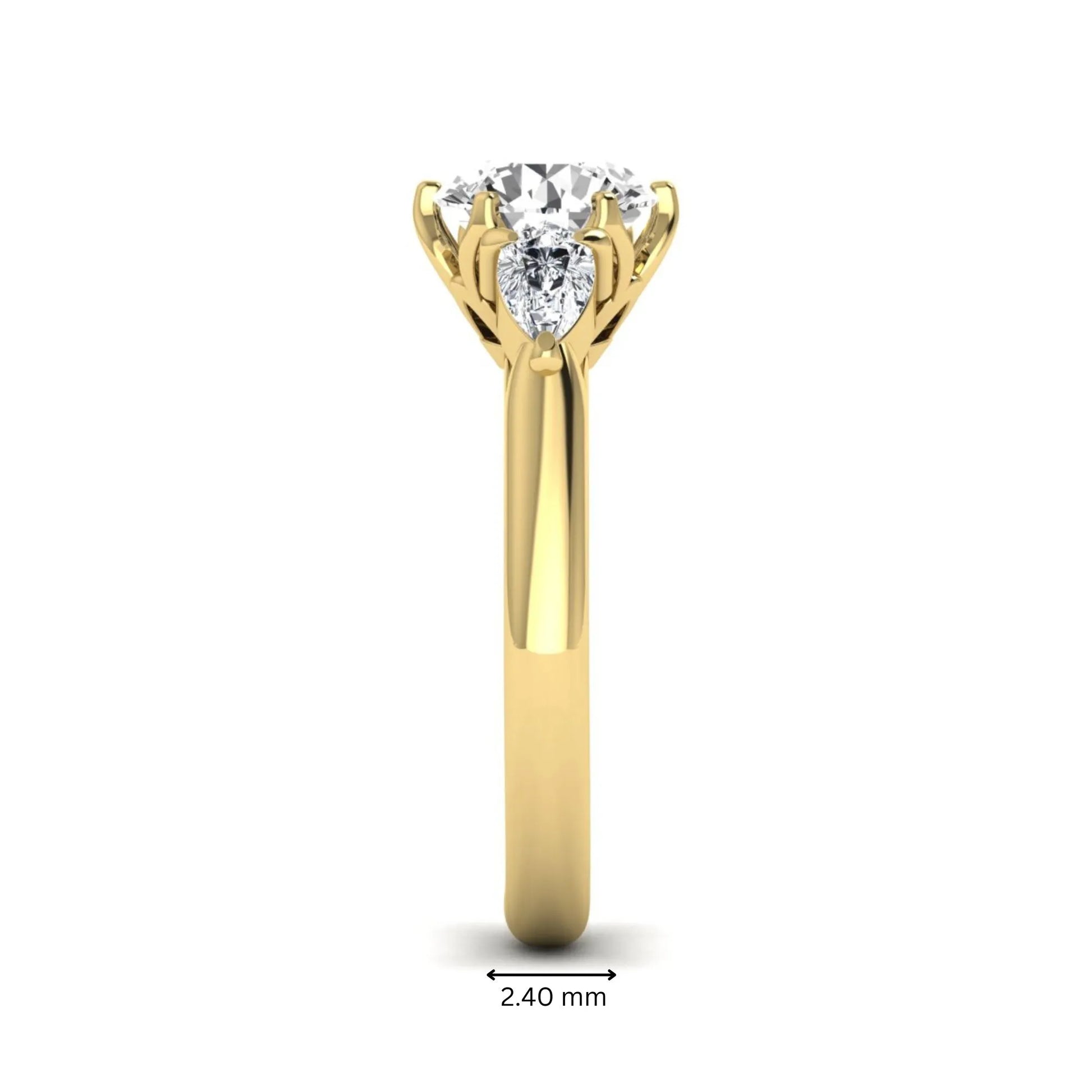Round cut lab grown diamond three stone engagement ring with pear side diamonds in yellow gold.