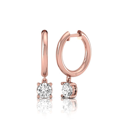 Round cut lab grown diamond drop huggie hoop earrings featuring a four prong drop setting, hinged snap closure, and polished rose gold tone finish.