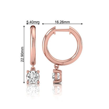 Round cut lab grown diamond drop huggie hoop earrings featuring a four prong drop setting, hinged snap closure, and polished rose gold tone finish.