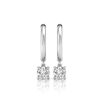Round cut lab grown diamond drop huggie hoop earrings featuring a four prong drop setting, hinged snap closure, and polished white gold tone finish.