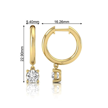 Round cut lab grown diamond drop huggie hoop earrings featuring a four prong drop setting, hinged snap closure, and polished yellow gold tone finish.