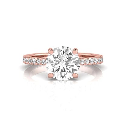 Round channel set lab grown diamond three stone ring with rose gold metal tone and modern geometric design.