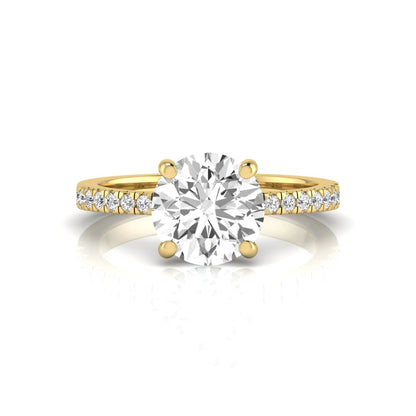 Round channel set lab grown diamond three stone ring with yellow gold metal tone and modern geometric design.