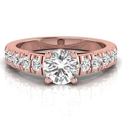 Round cut lab grown diamond side stone engagement ring featuring a four-prong setting with round accent diamonds in a rose gold tone design.
