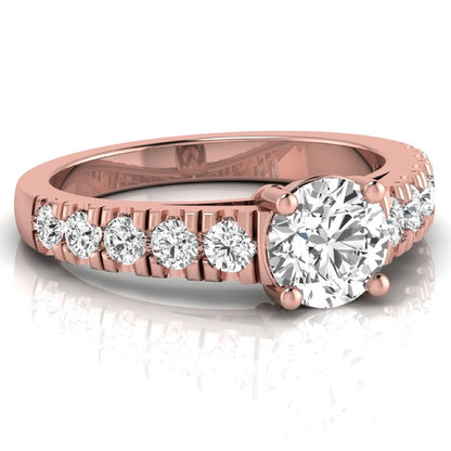Round cut lab grown diamond side stone engagement ring featuring a four-prong setting with round accent diamonds in a rose gold tone design.