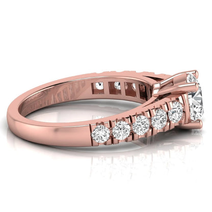 Round cut lab grown diamond side stone engagement ring featuring a four-prong setting with round accent diamonds in a rose gold tone design.