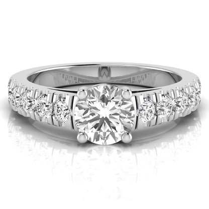 Round cut lab grown diamond side stone engagement ring featuring a four-prong setting with round accent diamonds in a white gold tone design.
