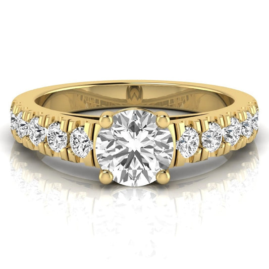 Round cut lab grown diamond side stone engagement ring featuring a four-prong setting with round accent diamonds in a yellow gold tone design.