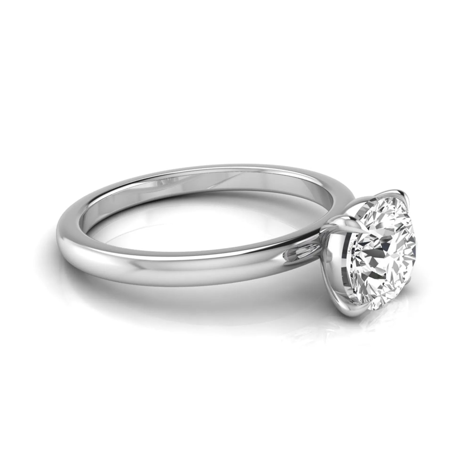 Round cut lab grown diamond solitaire engagement ring featuring a classic four-prong setting with a white gold tone band.