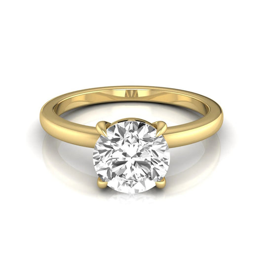 Round cut lab grown diamond solitaire engagement ring featuring a classic four-prong setting with a yellow gold tone band.