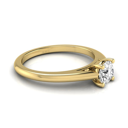 Round cut lab grown diamond solitaire engagement ring featuring a classic four-prong setting with a yellow gold tone band.