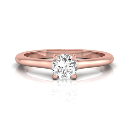Round four prong lab grown diamond solitaire engagement ring featuring a 0.60 carat round cut center diamond in a classic rose gold design.