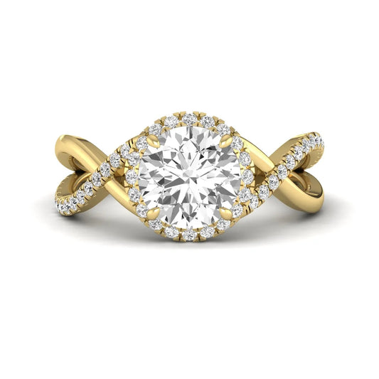 Round cut lab grown diamond halo engagement ring featuring a bypass split shank with pavé round diamonds in a yellow gold tone design.