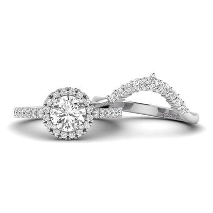 Round cut lab grown diamond halo bridal ring set featuring a pavé engagement ring with matching curved diamond wedding band in white gold finish.