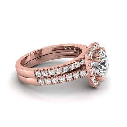 Round cut lab grown diamond halo bridal ring set featuring a split pavé engagement ring with matching diamond wedding band in rose gold finish.