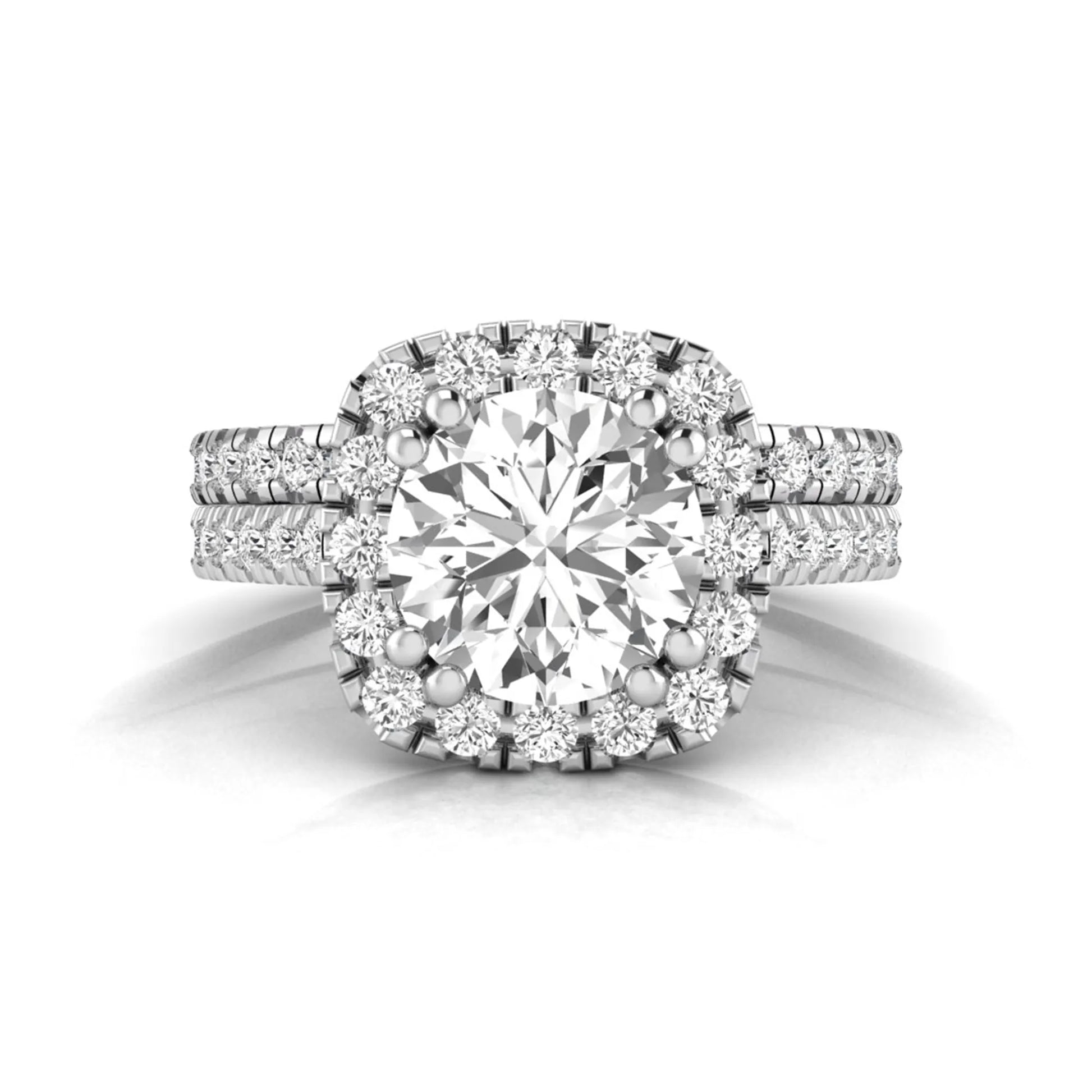Round cut lab grown diamond halo bridal ring set featuring a split pavé engagement ring with matching diamond wedding band in white gold finish.