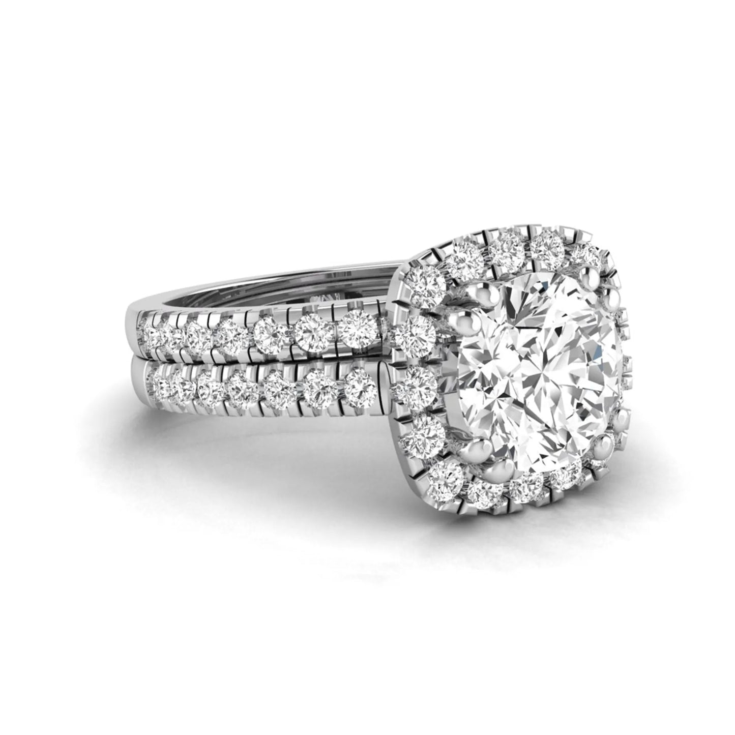 Round cut lab grown diamond halo bridal ring set featuring a split pavé engagement ring with matching diamond wedding band in white gold finish.