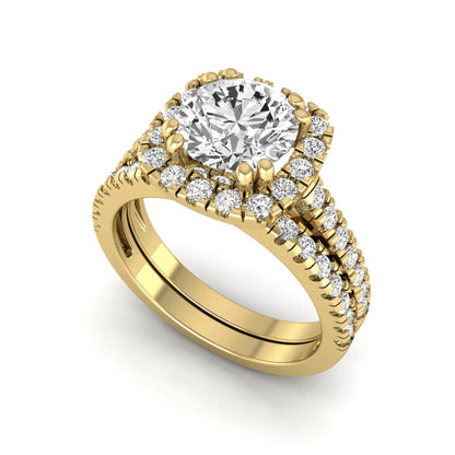 Round cut lab grown diamond halo bridal ring set featuring a split pavé engagement ring with matching diamond wedding band in yellow gold finish.