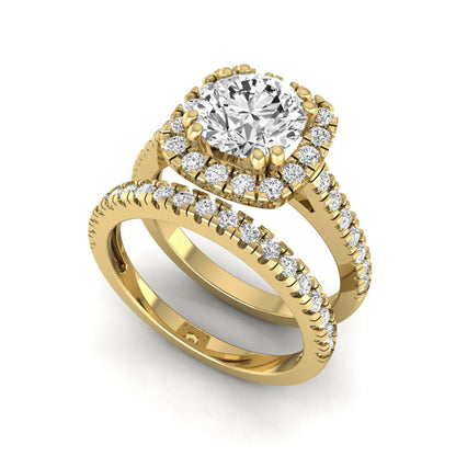 Round cut lab grown diamond halo bridal ring set featuring a split pavé engagement ring with matching diamond wedding band in yellow gold finish.