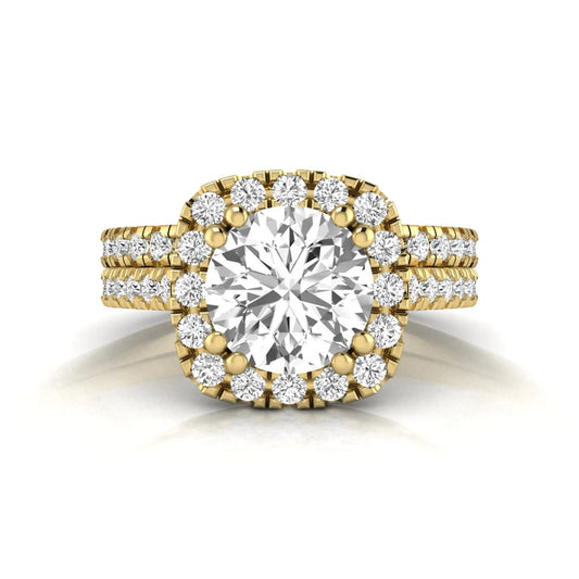 Round cut lab grown diamond halo bridal ring set featuring a split pavé engagement ring with matching diamond wedding band in yellow gold finish.