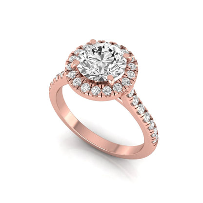 Round cut lab grown diamond engagement ring featuring a 1.33 carat center diamond surrounded by a round halo with a pavé diamond band and polished rose gold finish.