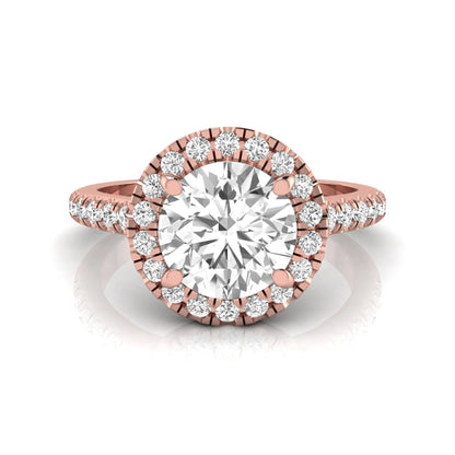 Round cut lab grown diamond engagement ring featuring a 1.33 carat center diamond surrounded by a round halo with a pavé diamond band and polished rose gold finish.