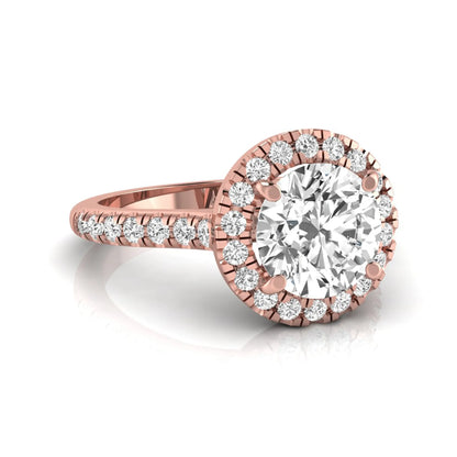 Round cut lab grown diamond engagement ring featuring a 1.33 carat center diamond surrounded by a round halo with a pavé diamond band and polished rose gold finish.