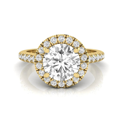 Round cut lab grown diamond engagement ring featuring a 1.33 carat center diamond surrounded by a round halo with a pavé diamond band and polished yellow gold finish.