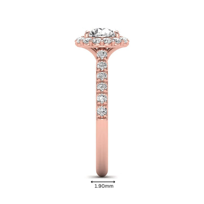 Round halo lab grown diamond engagement ring featuring a 6.50 mm round center diamond with pavé band and prong-set halo in a rose gold tone design.