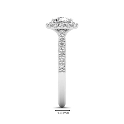 Round halo lab grown diamond engagement ring featuring a 6.50 mm round center diamond with pavé band and prong-set halo in a white gold tone design.