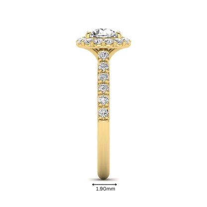 Round halo lab grown diamond engagement ring featuring a 6.50 mm round center diamond with pavé band and prong-set halo in a yellow gold tone design.