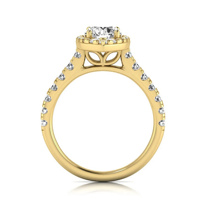 Round cut lab grown diamond engagement ring with a sparkling halo, pavé side stones, and four-prong setting in yellow gold style.