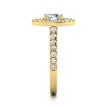 Round cut lab grown diamond engagement ring with a sparkling halo, pavé side stones, and four-prong setting in yellow gold style.