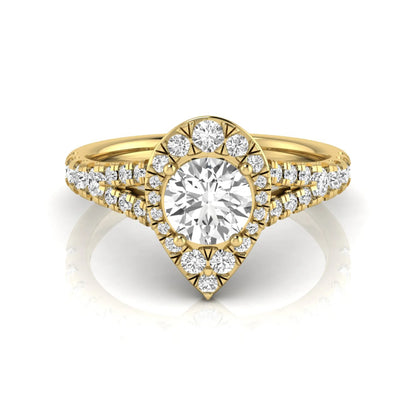 Round halo split shank lab grown diamond engagement ring featuring a round center diamond with pavé halo, cathedral gallery, and pavé-set split shank in yellow gold tone.