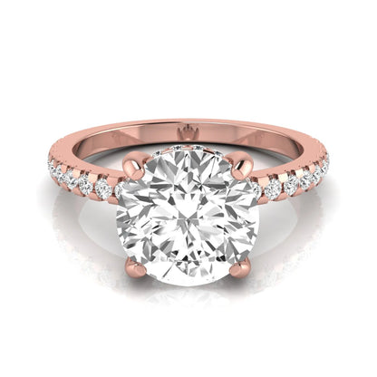 Round cut lab grown diamond engagement ring featuring a hidden halo, pavé accent side diamonds, and a four-prong setting in a rose gold tone with an IGI certified 1.28 carat center diamond.