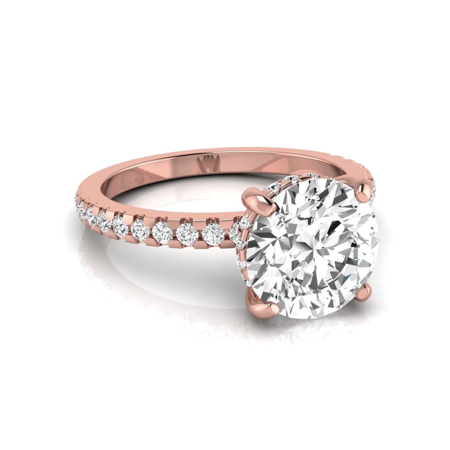 Round cut lab grown diamond engagement ring featuring a hidden halo, pavé accent side diamonds, and a four-prong setting in a rose gold tone with an IGI certified 1.28 carat center diamond.