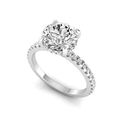 Round cut lab grown diamond engagement ring featuring a hidden halo, pavé accent side diamonds, and a four-prong setting in a white gold tone with an IGI certified 1.28 carat center diamond.