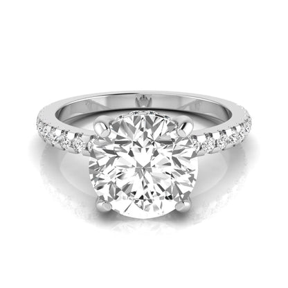 Round cut lab grown diamond engagement ring featuring a hidden halo, pavé accent side diamonds, and a four-prong setting in a white gold tone with an IGI certified 1.28 carat center diamond.